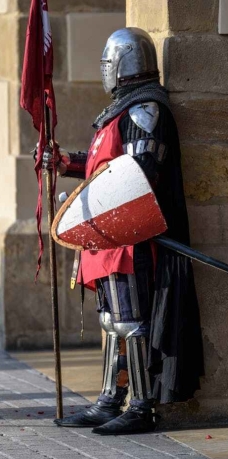 man wearing gray and red armour standing on the streets